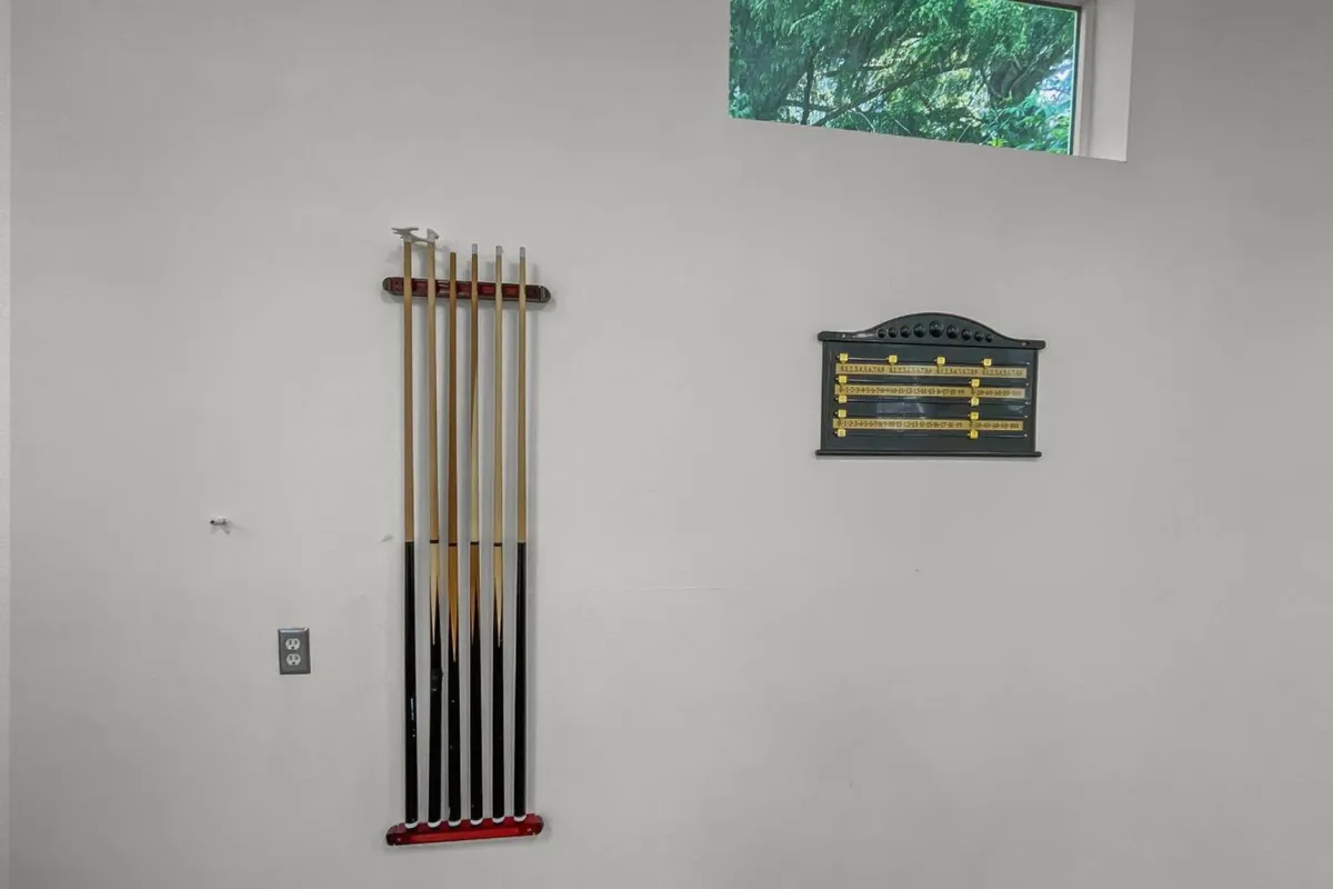This interior shot focuses on a playful game room scene, with pool cues and a scoreboard visible, evoking the excitement of friendly competition. The room is set up for activities like pool and ping pong, echoing the retreat’s promise of indoor fun for all ages regardless of the weather.